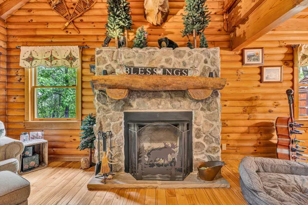 a living room with a fireplace and windows