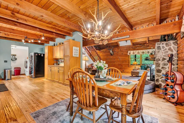 a view of a kitchen with a sink and wooden cabinets