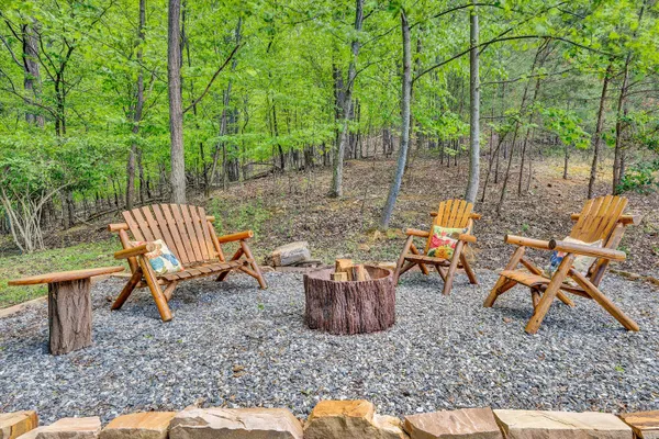 a wooden bench sitting in the middle of a yard