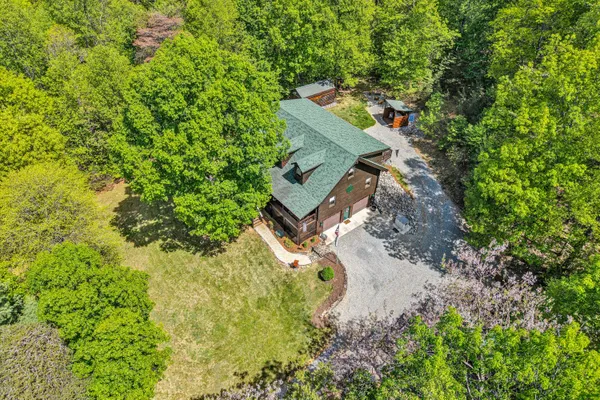 an aerial view of a house with a yard