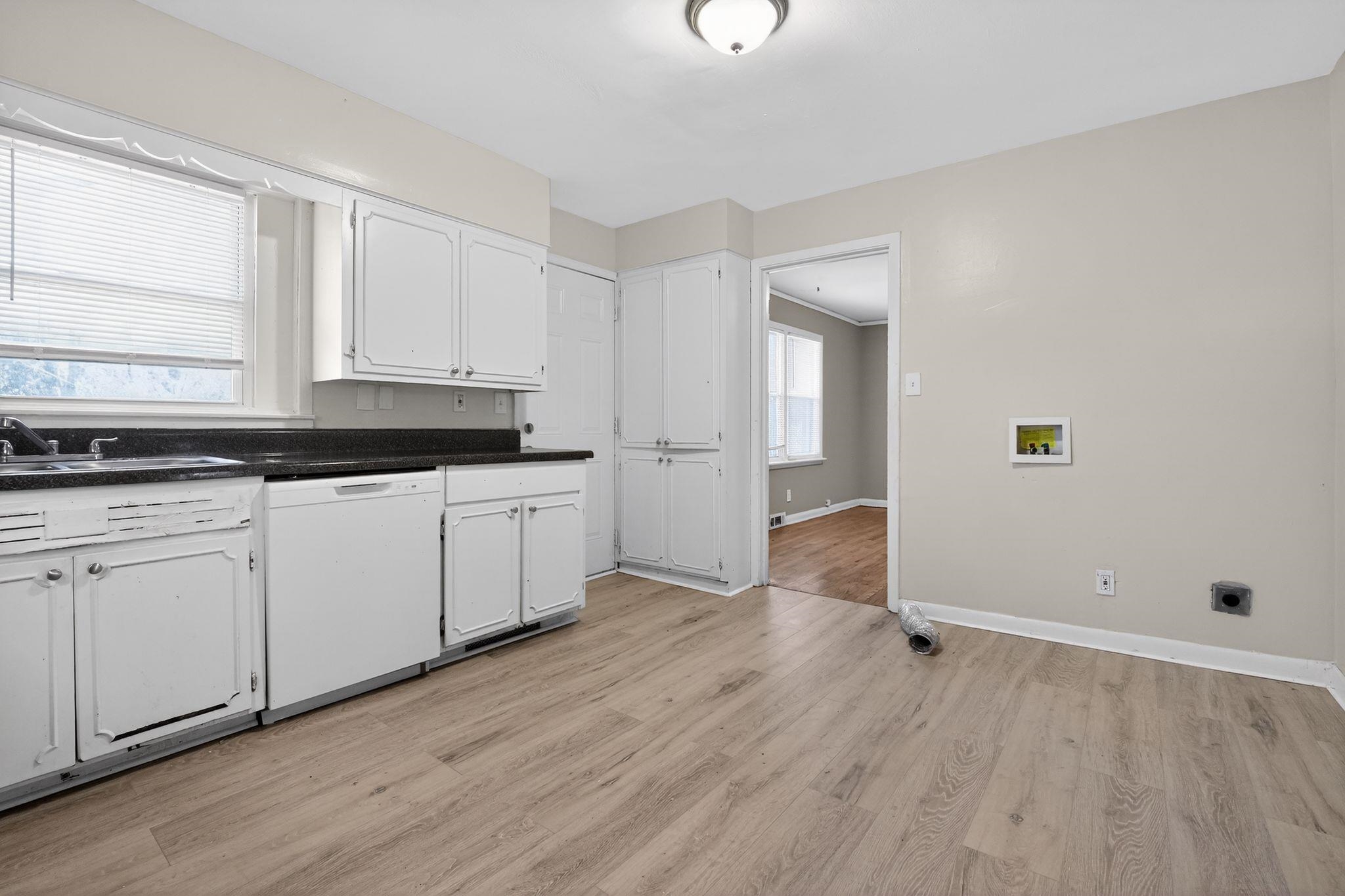 4094 Auburn Road Memphis, TN 38116 - Photo 13 of 30 Kitchen with dishwasher, white cabinetry, and light wood finished floors