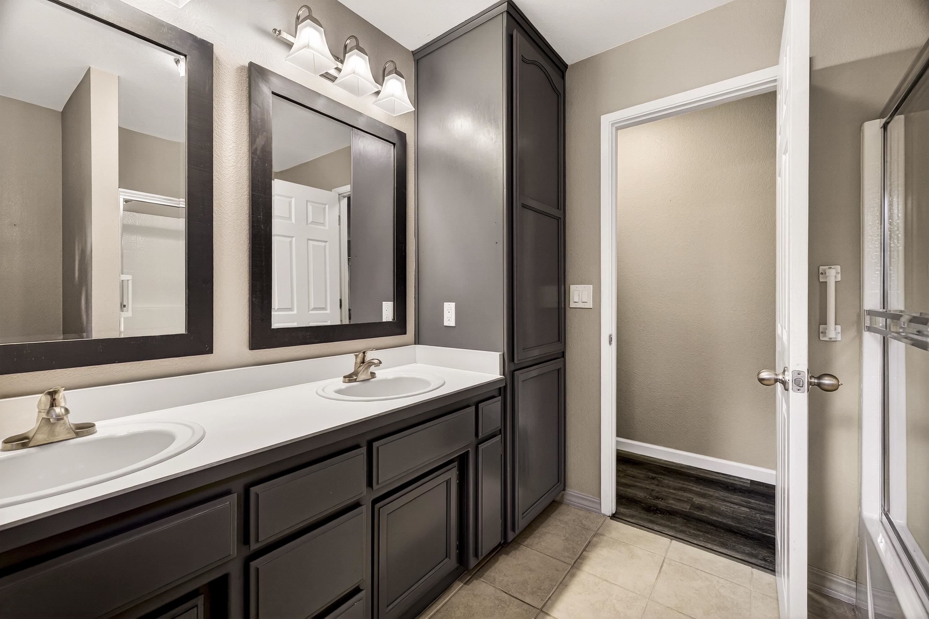 811 Golf Club Road Lake Almanor, CA 96137 - Photo 30 of 42 a bathroom with a double vanity sink and mirror with shower