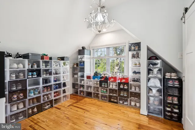 a room with books and a large window