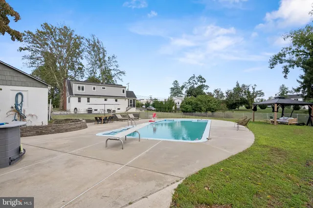 a view of a field with trees in the background