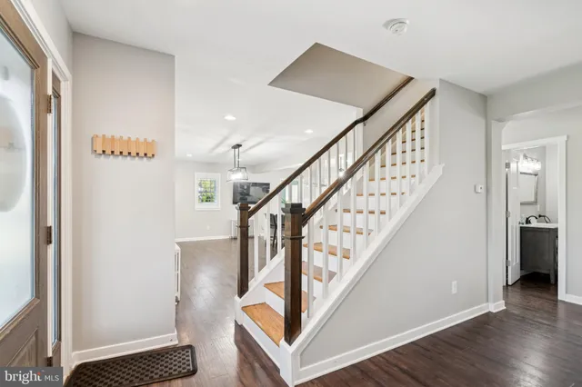 a view of entryway and hall with wooden floor