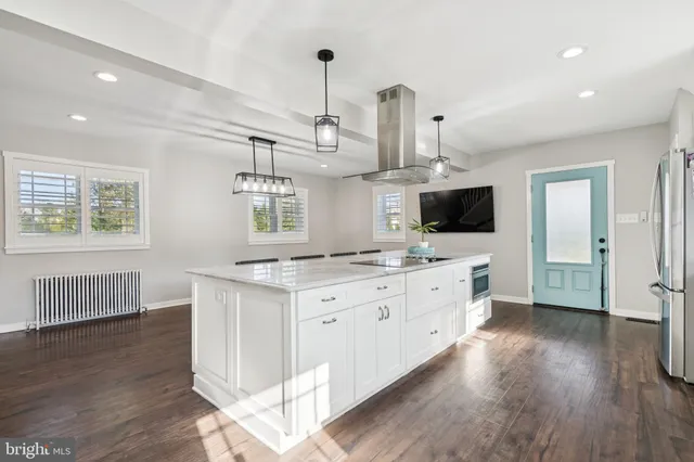 a kitchen with granite countertop white cabinets and stainless steel appliances