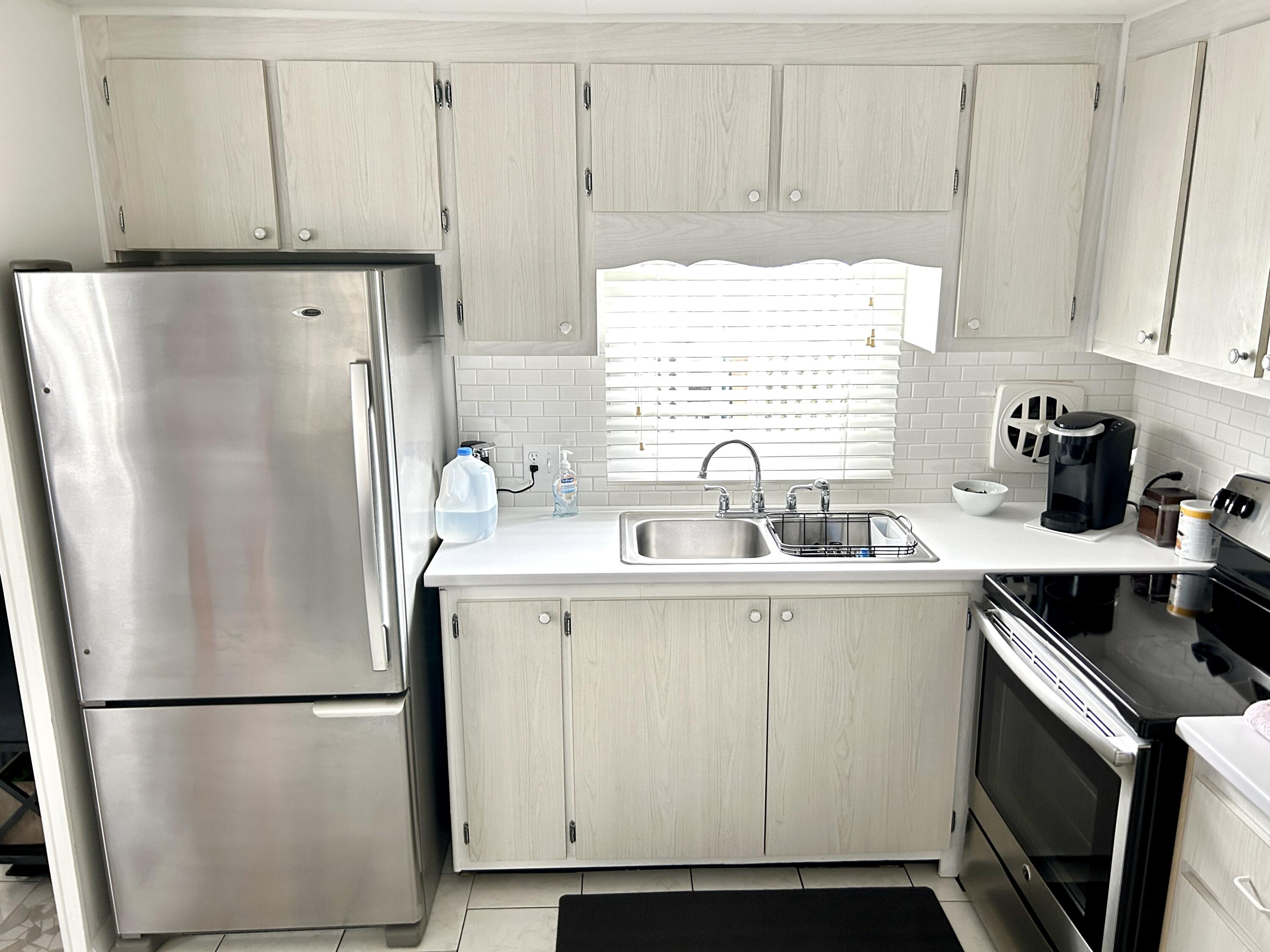 3240 State Street Hollywood, FL 33021 - Photo 11 of 29 a white refrigerator freezer sitting inside of a kitchen