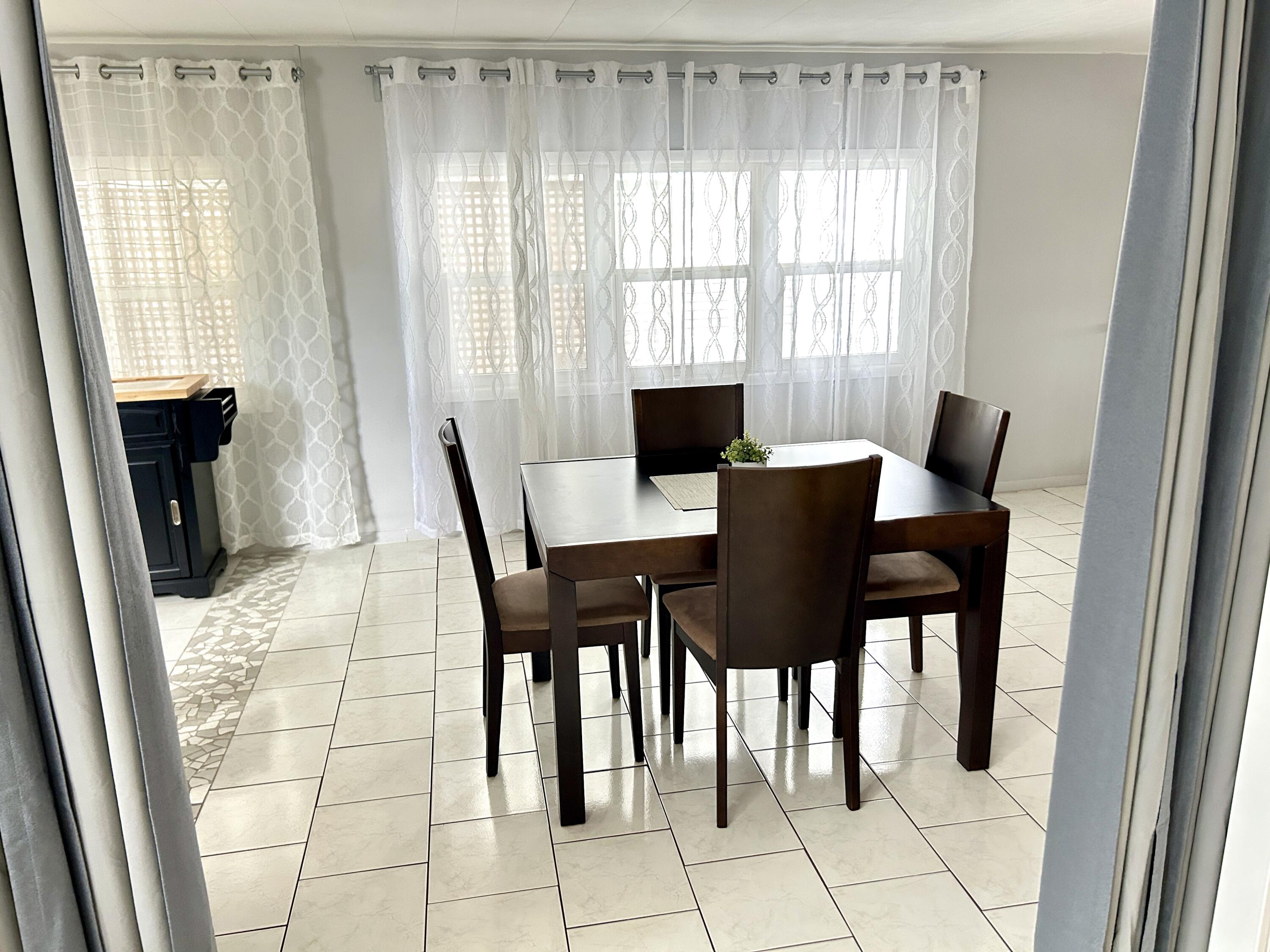 3240 State Street Hollywood, FL 33021 - Photo 13 of 29 a view of a dining room with furniture and a window