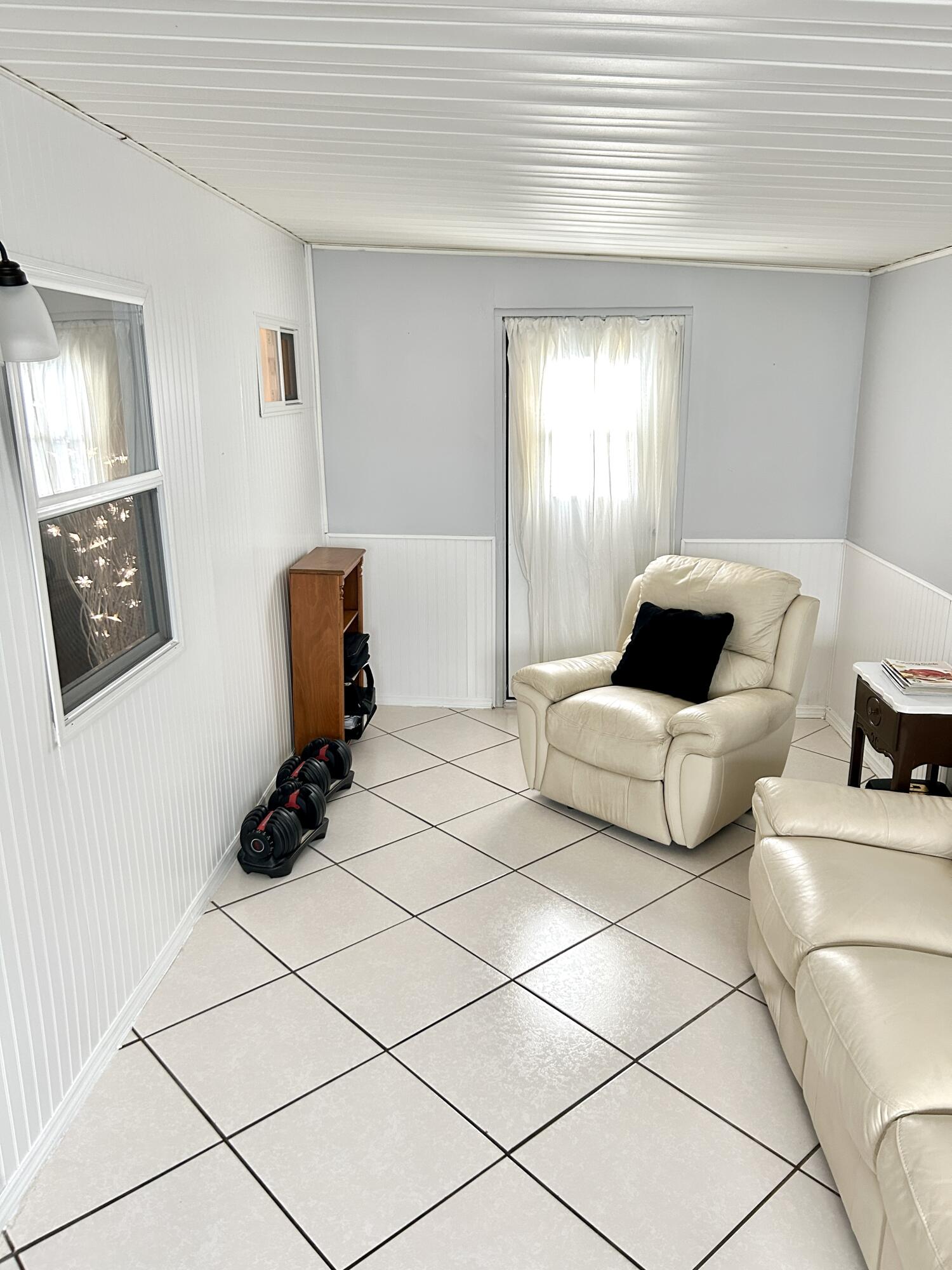 3240 State Street Hollywood, FL 33021 - Photo 14 of 29 a bedroom with a bed a couch and a window