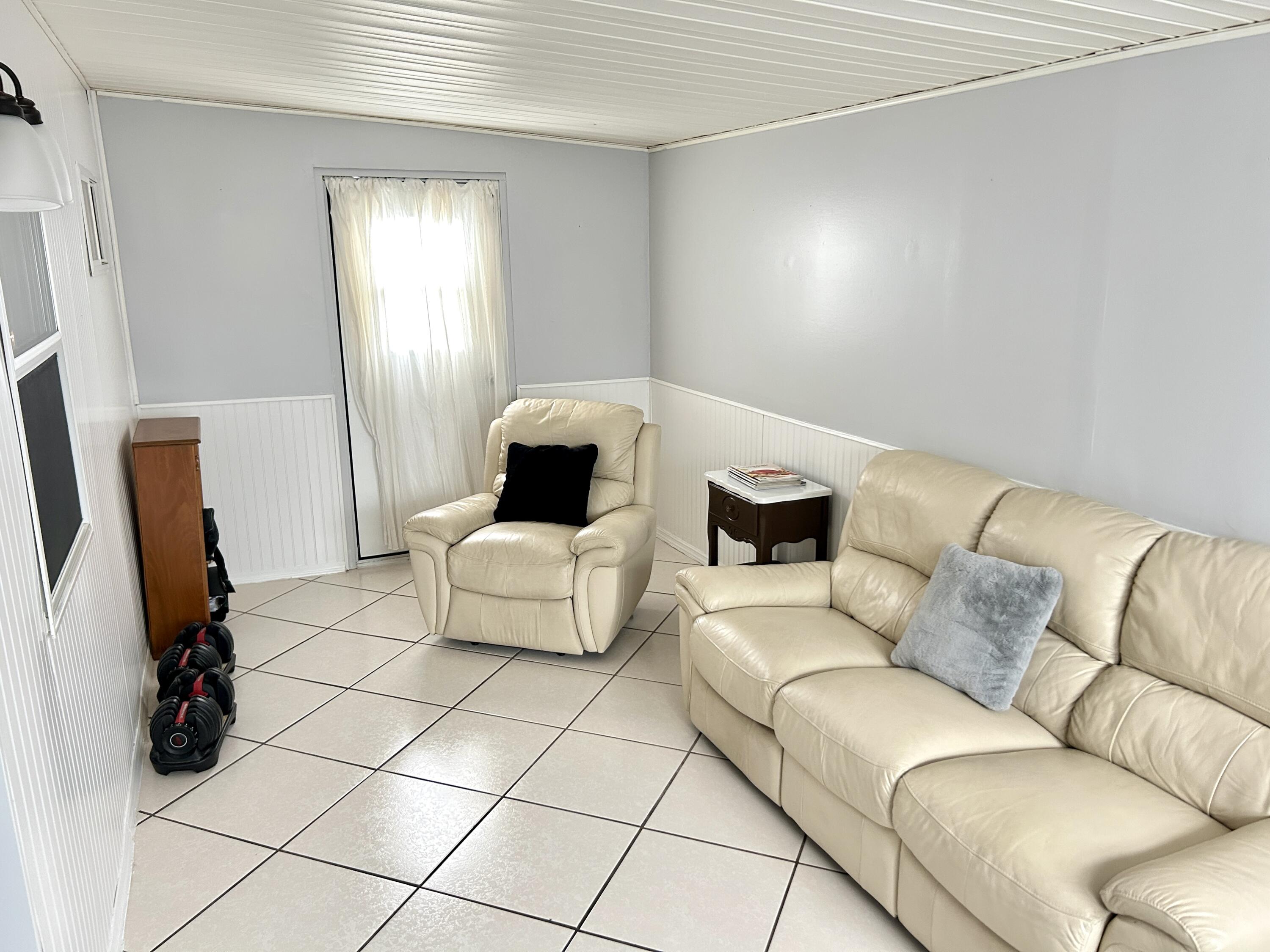 3240 State Street Hollywood, FL 33021 - Photo 21 of 29 a living room with furniture and a flat screen tv