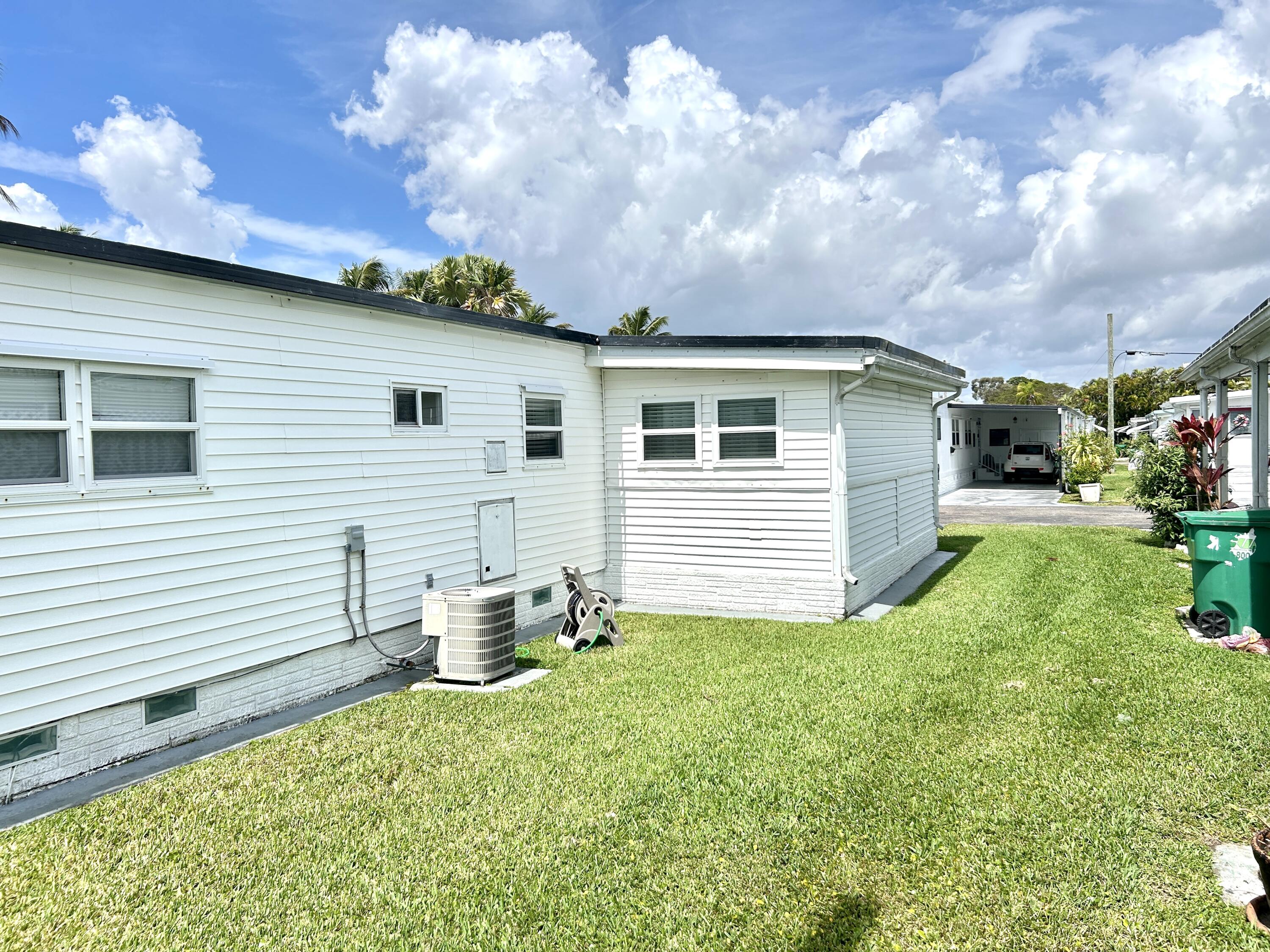3240 State Street Hollywood, FL 33021 - Photo 28 of 29 a backyard of a house with table and chairs and potted plants