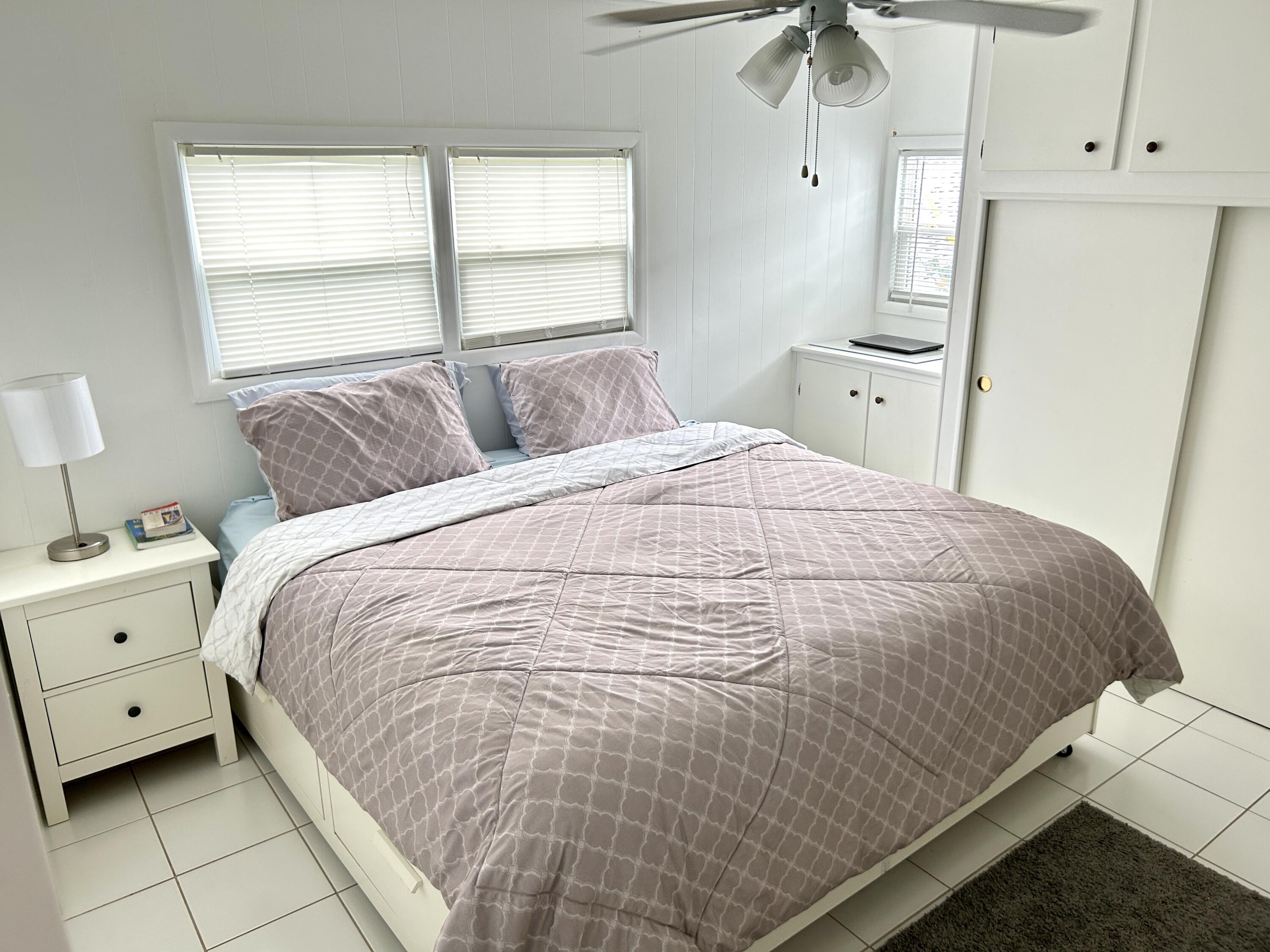 3240 State Street Hollywood, FL 33021 - Photo 5 of 29 a large bed sitting in a bedroom next to a window