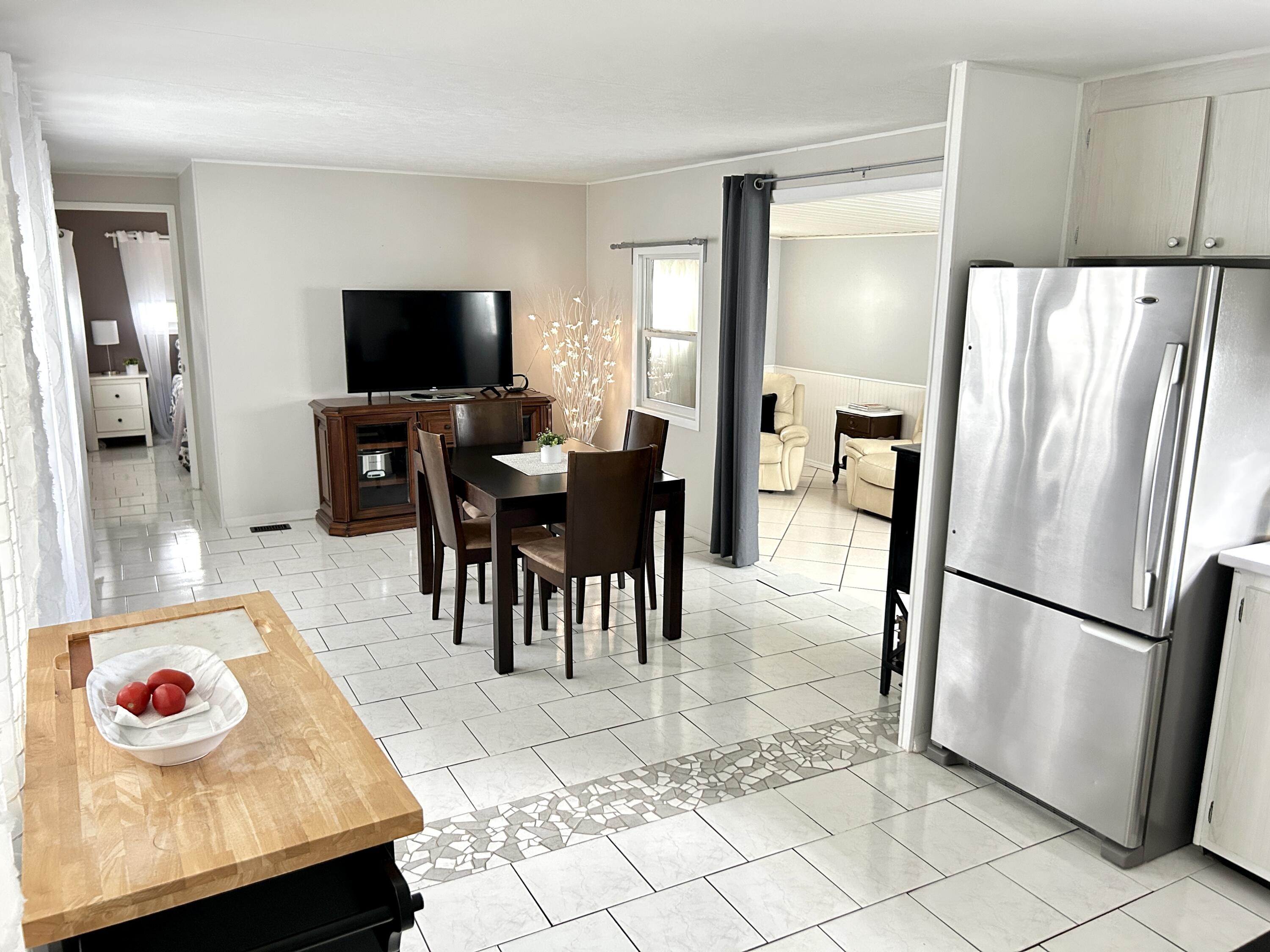 3240 State Street Hollywood, FL 33021 - Photo 10 of 29 a kitchen with stainless steel appliances granite countertop a refrigerator a stove a sink a dining table and chairs