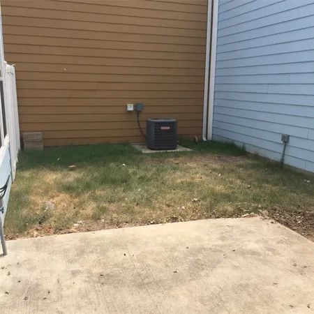 a backyard of a house with a yard and tree