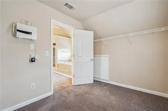 a spacious bathroom with a shower sink and mirror