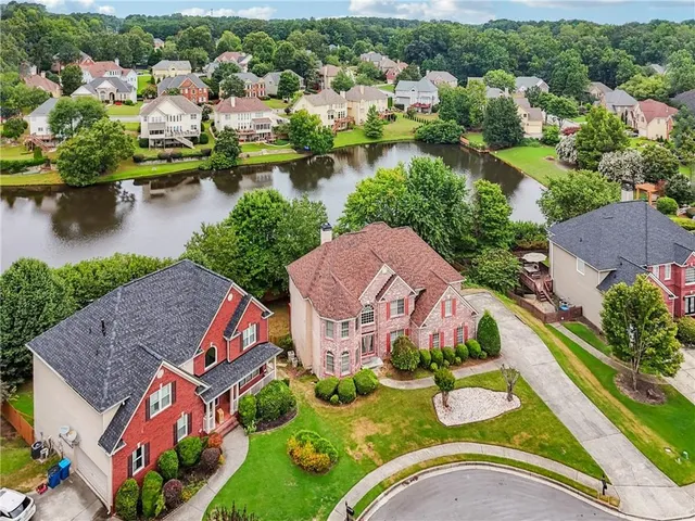 an aerial view of a house with a yard