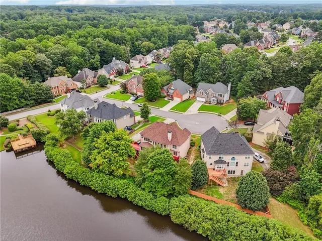 a view of a house with a yard and a street