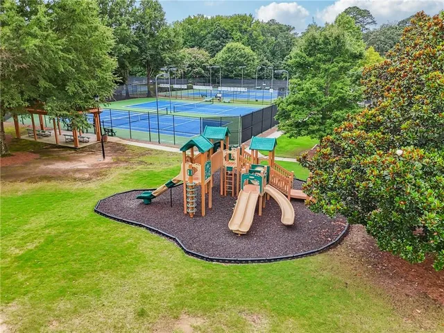 an aerial view of a tennis ground and a yard