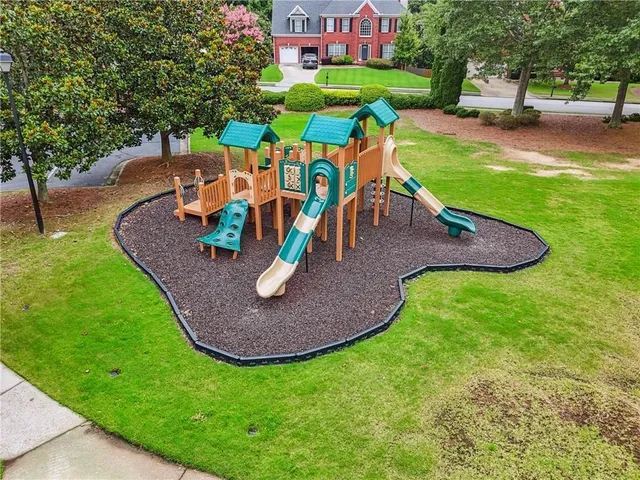 an aerial view of a house with a yard