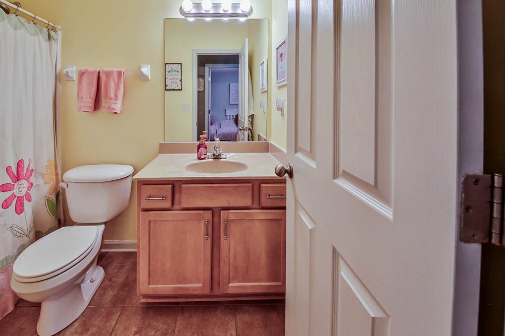4964 Shaws Ridge Trail Arlington, TN 38002 - Photo 13 of 20 a bathroom with a toilet sink vanity and mirror