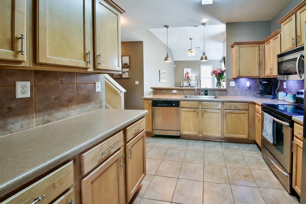 4964 Shaws Ridge Trail Arlington, TN 38002 - Photo 2 of 20 a kitchen with a sink a stove top oven and cabinets