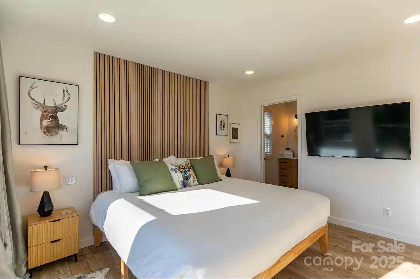 4612 Shulls Mill Road Blowing Rock, NC 28605 - Photo 17 of 35 a bedroom with a large bed and a flat screen tv