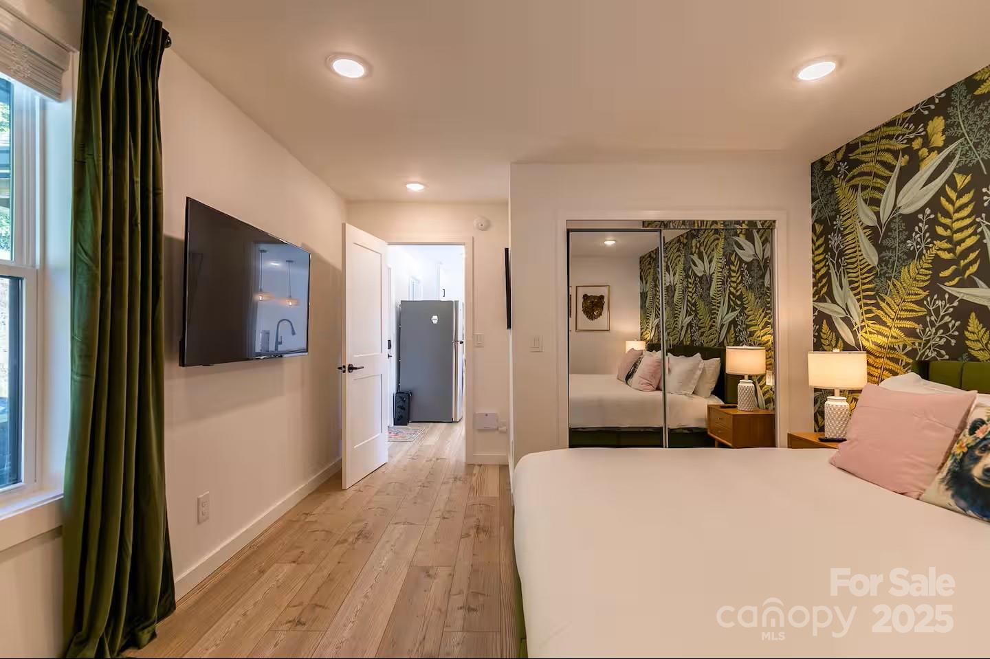 4612 Shulls Mill Road Blowing Rock, NC 28605 - Photo 24 of 35 a bedroom with a bed and a large mirror