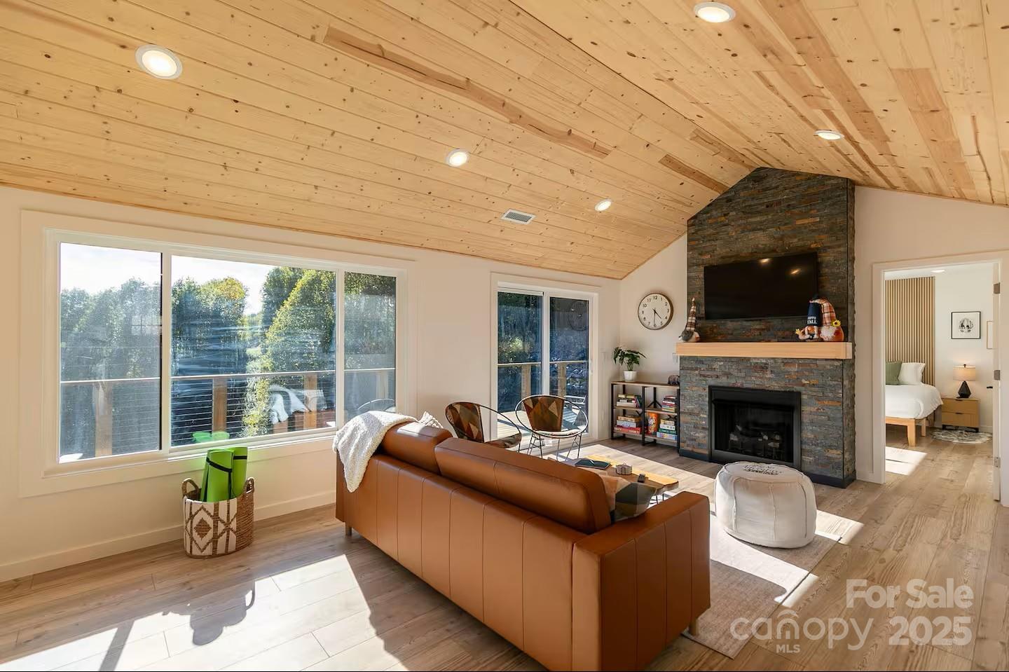 4612 Shulls Mill Road Blowing Rock, NC 28605 - Photo 4 of 35 a living room with furniture a fireplace and a floor to ceiling window