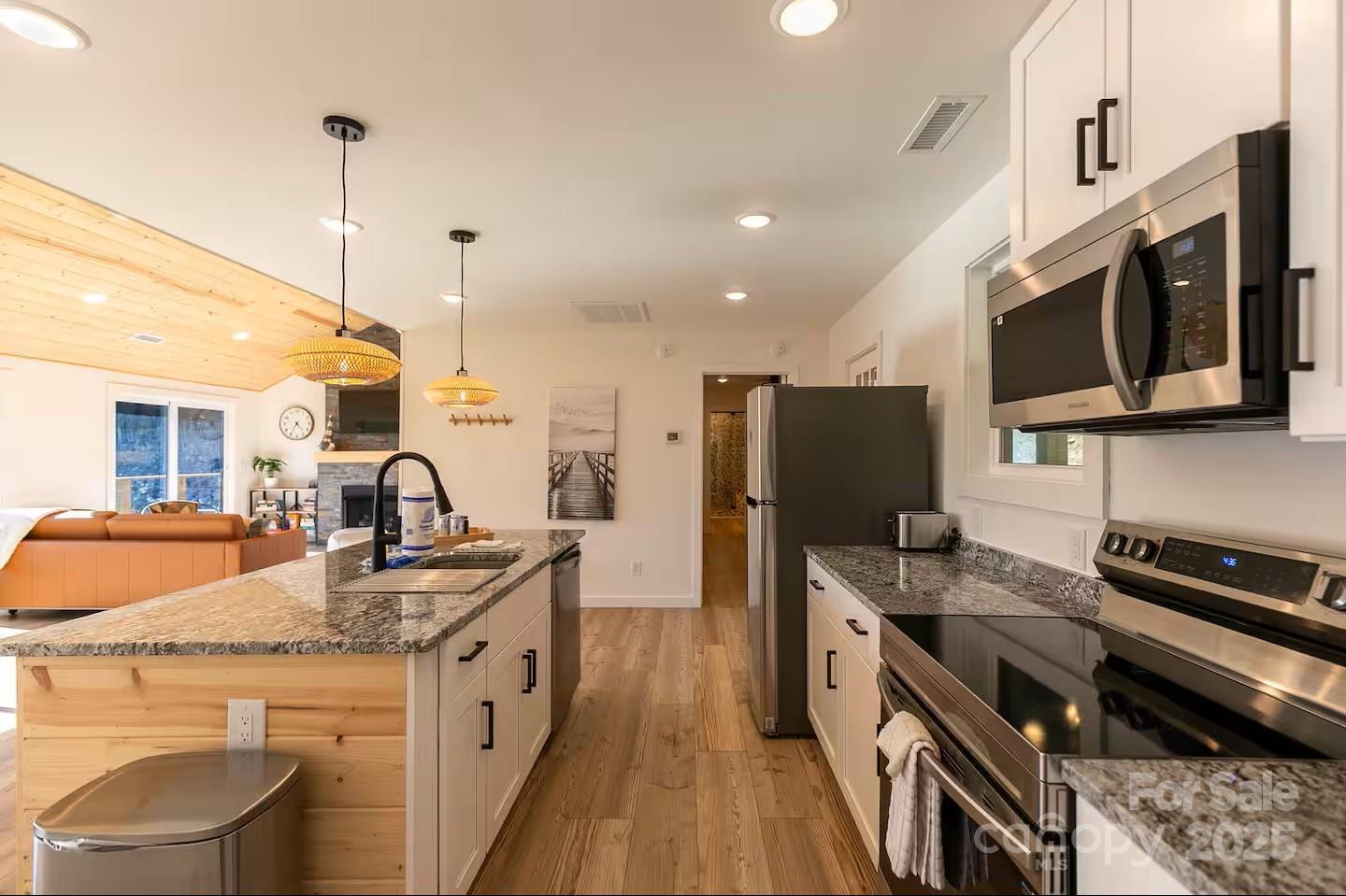 4612 Shulls Mill Road Blowing Rock, NC 28605 - Photo 10 of 35 a kitchen with stainless steel appliances granite countertop a sink stove and refrigerator
