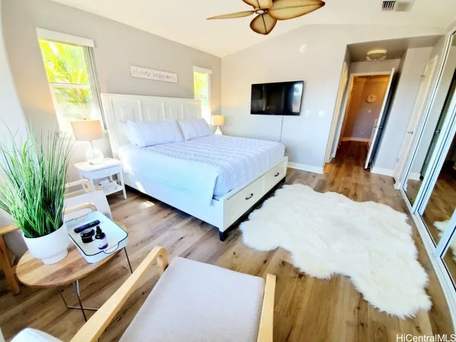 a bedroom with a bed window and couch