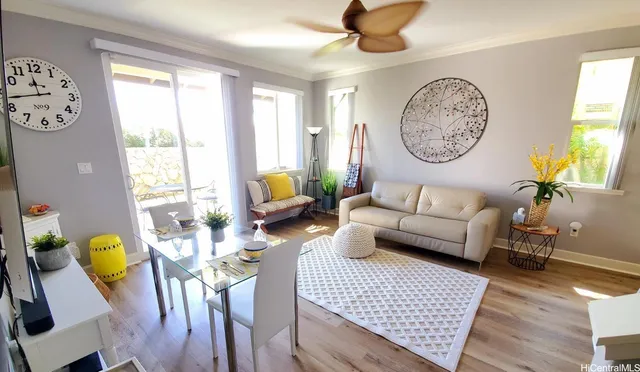 a living room with furniture a clock on wall and a window