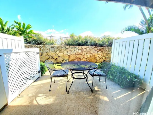 a backyard of a house with table and chairs