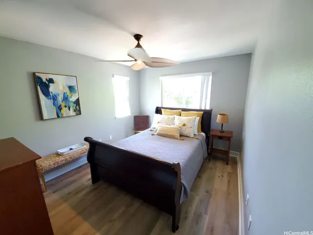 a bedroom with a bed and wooden floor