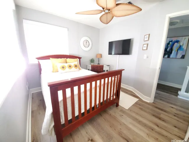 a bedroom with a bed and flat screen tv