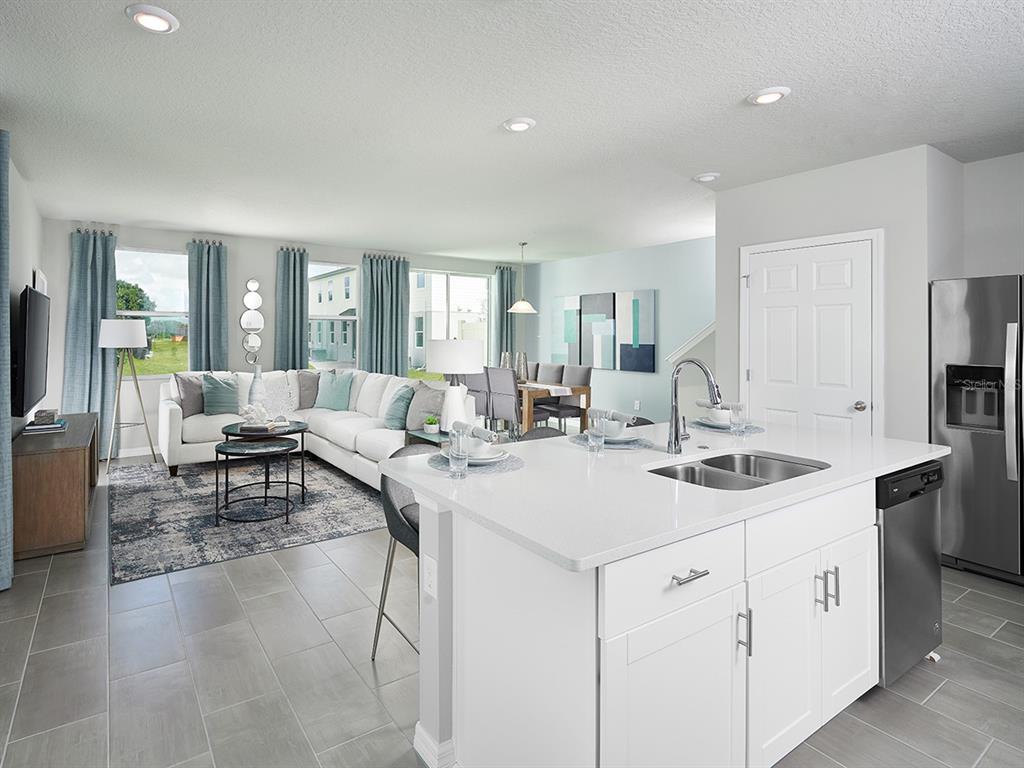 4536 Burrowing Owl Loop St. Cloud, FL 34772 - Photo 2 of 7 a view of kitchen island a sink and living room