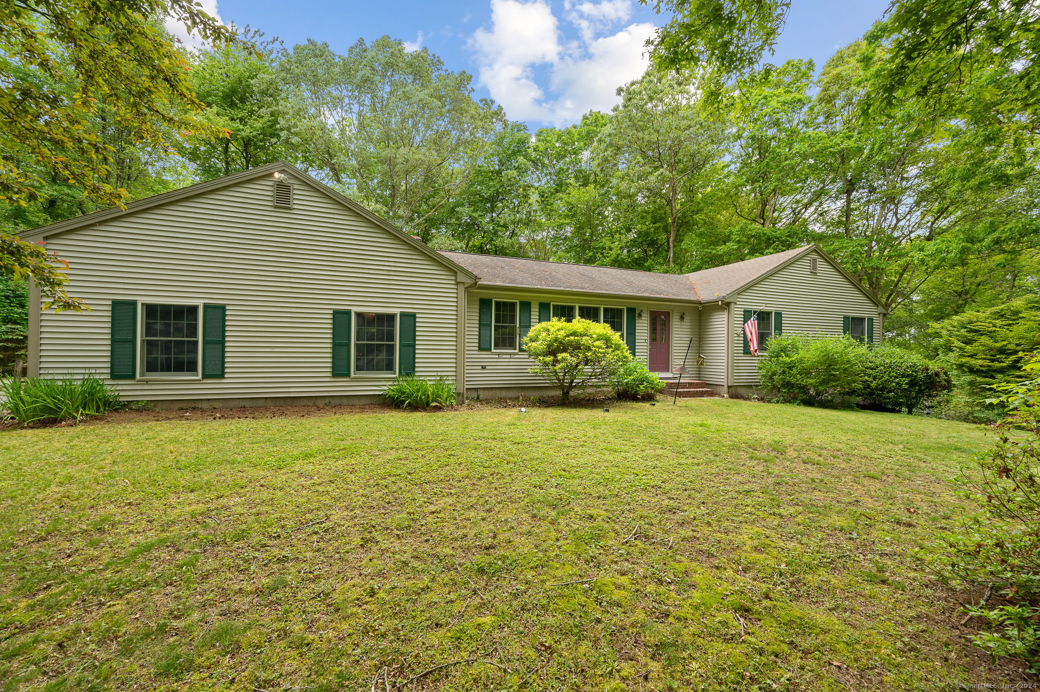 a front view of house with yard and green space