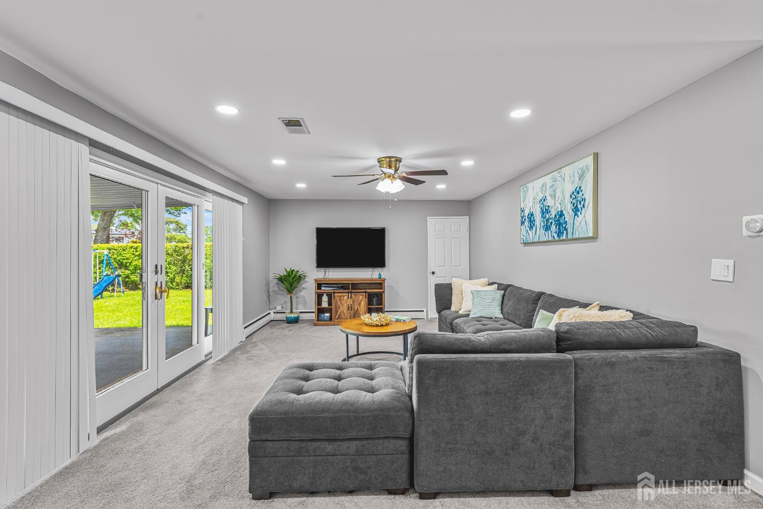 23 Carmello Drive Edison, NJ 08817 - Photo 11 of 28 a living room with furniture and a flat screen tv