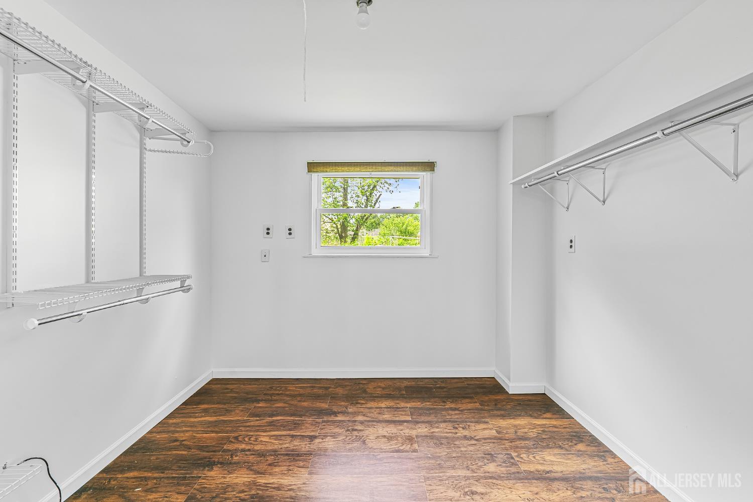23 Carmello Drive Edison, NJ 08817 - Photo 18 of 28 a view of an empty room with wooden floor and a window