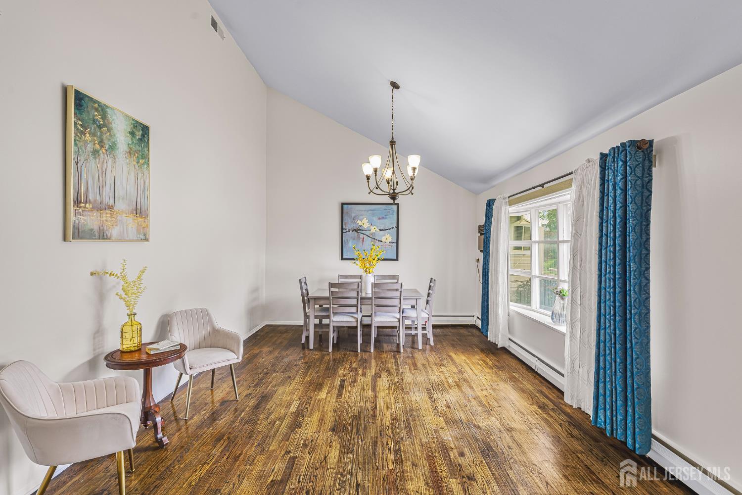 23 Carmello Drive Edison, NJ 08817 - Photo 2 of 28 a dining room with furniture a chandelier and wooden floor