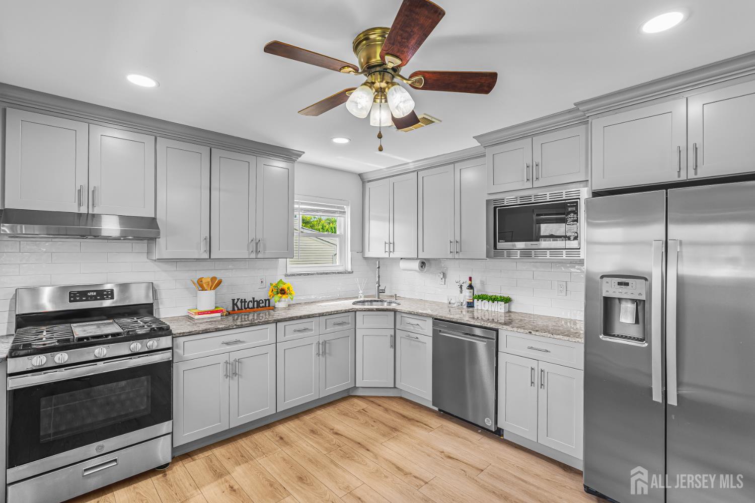 23 Carmello Drive Edison, NJ 08817 - Photo 5 of 28 a kitchen with a sink stainless steel appliances and cabinets
