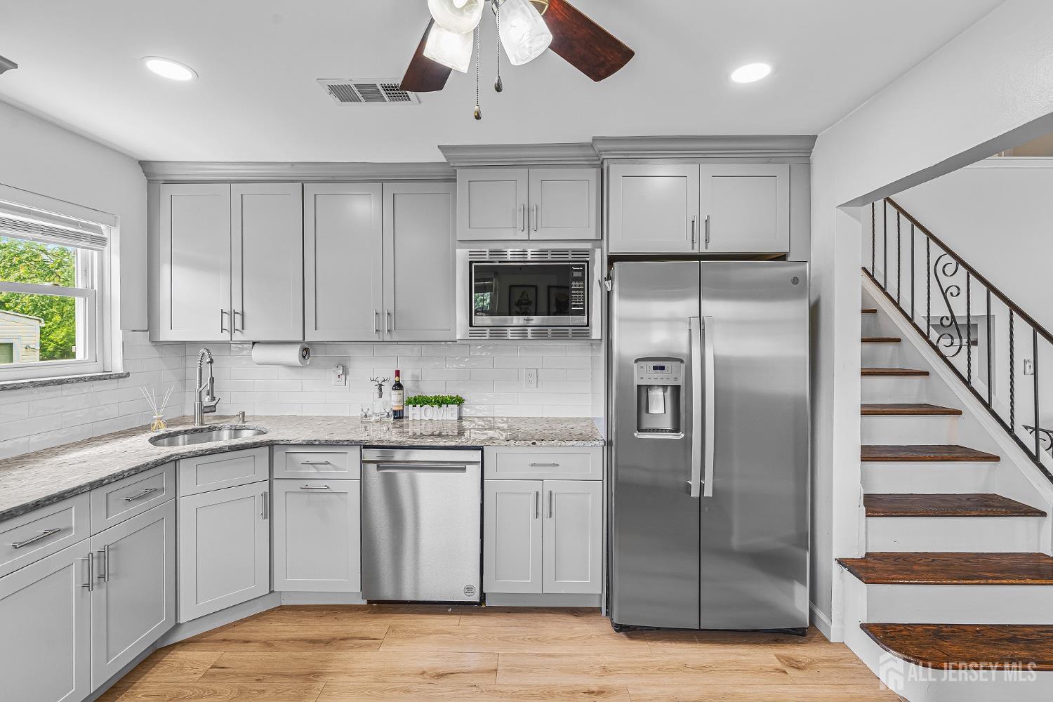 23 Carmello Drive Edison, NJ 08817 - Photo 6 of 28 a kitchen with a sink stainless steel appliances and cabinets