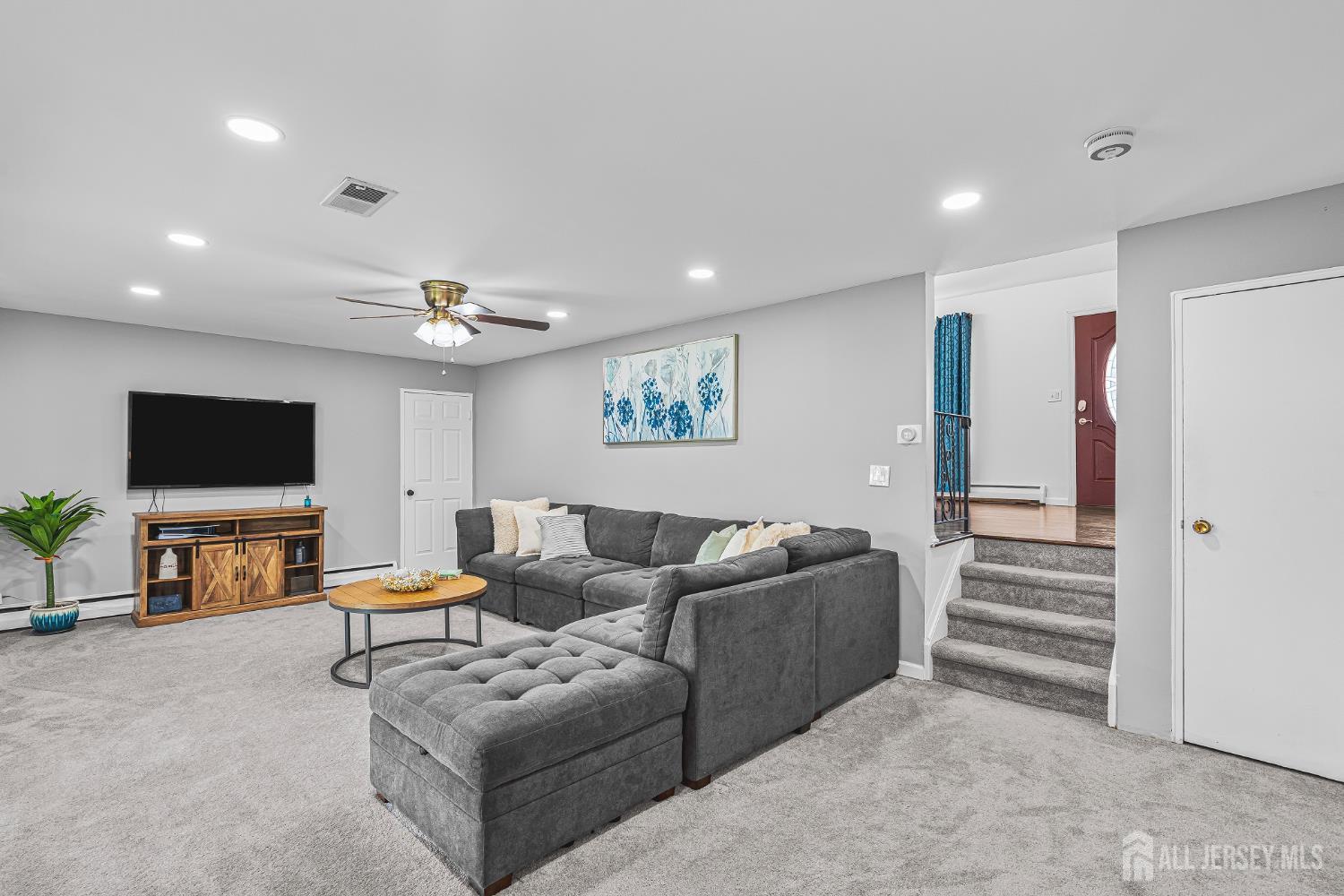 23 Carmello Drive Edison, NJ 08817 - Photo 9 of 28 a living room with furniture and a flat screen tv