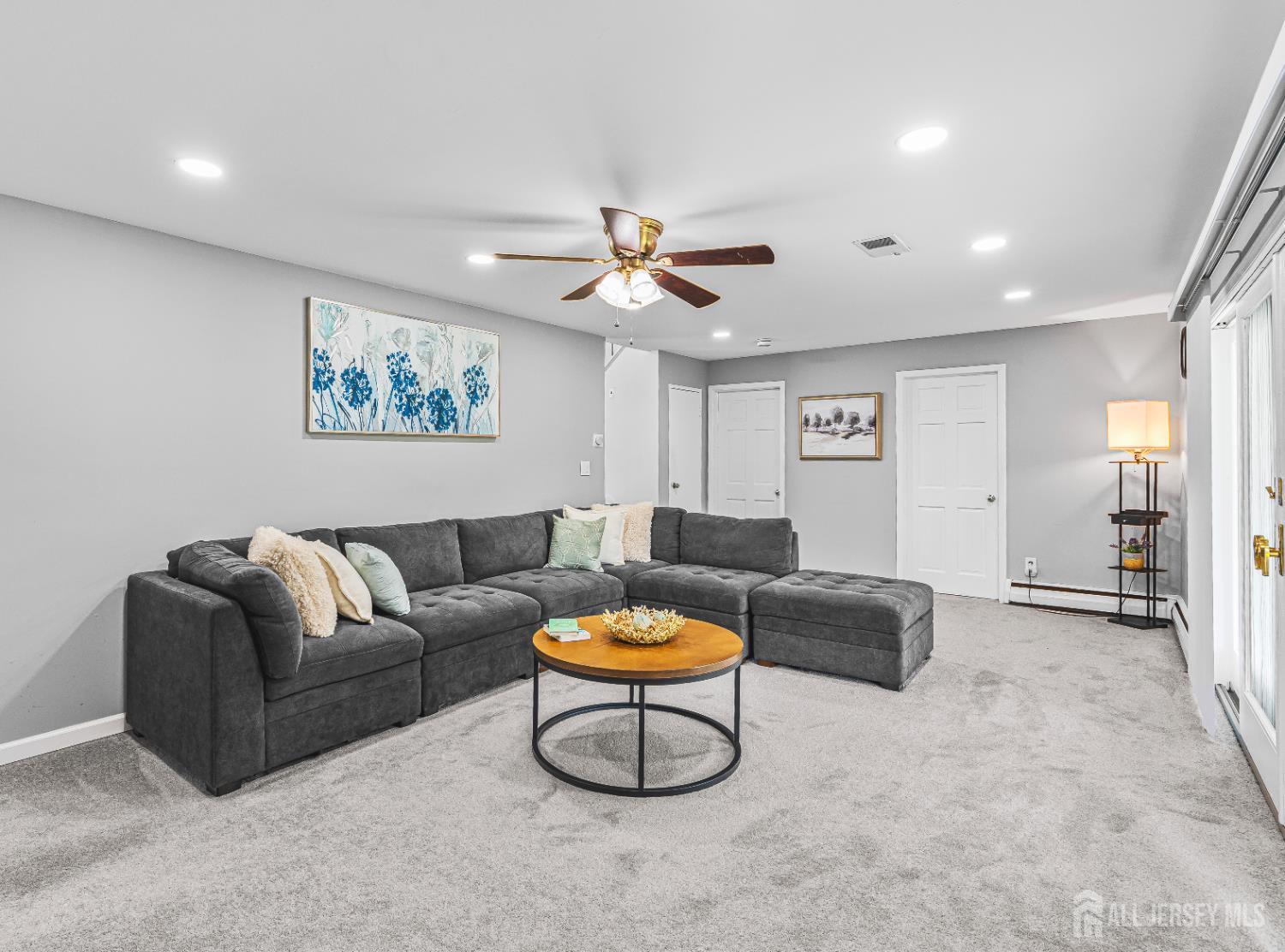 23 Carmello Drive Edison, NJ 08817 - Photo 10 of 28 a living room with furniture a rug and a ceiling fan