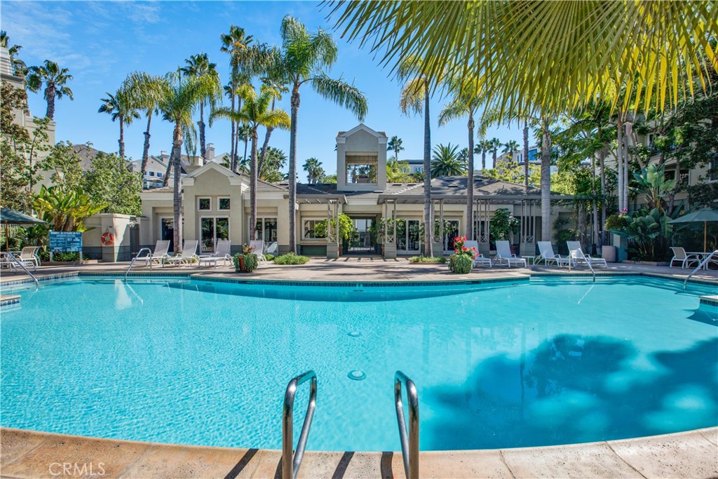 a swimming pool view with a outdoor seating