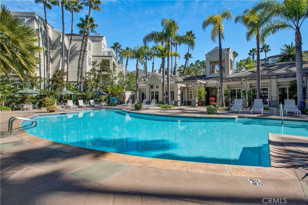 2243 Martin, Unit 409 Irvine, CA 92612 - Photo 23 of 31 a view of a swimming pool with a yard and palm trees
