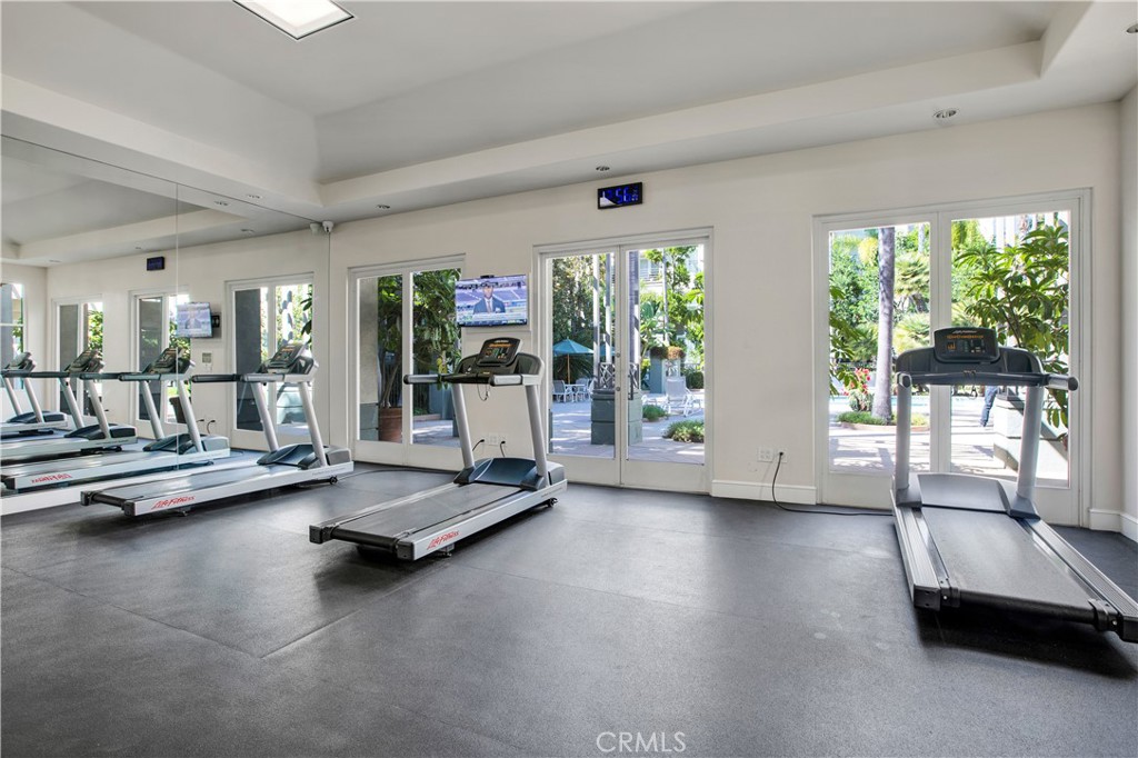 2243 Martin, Unit 409 Irvine, CA 92612 - Photo 27 of 31 a view of a room with gym equipment and floor to ceiling window
