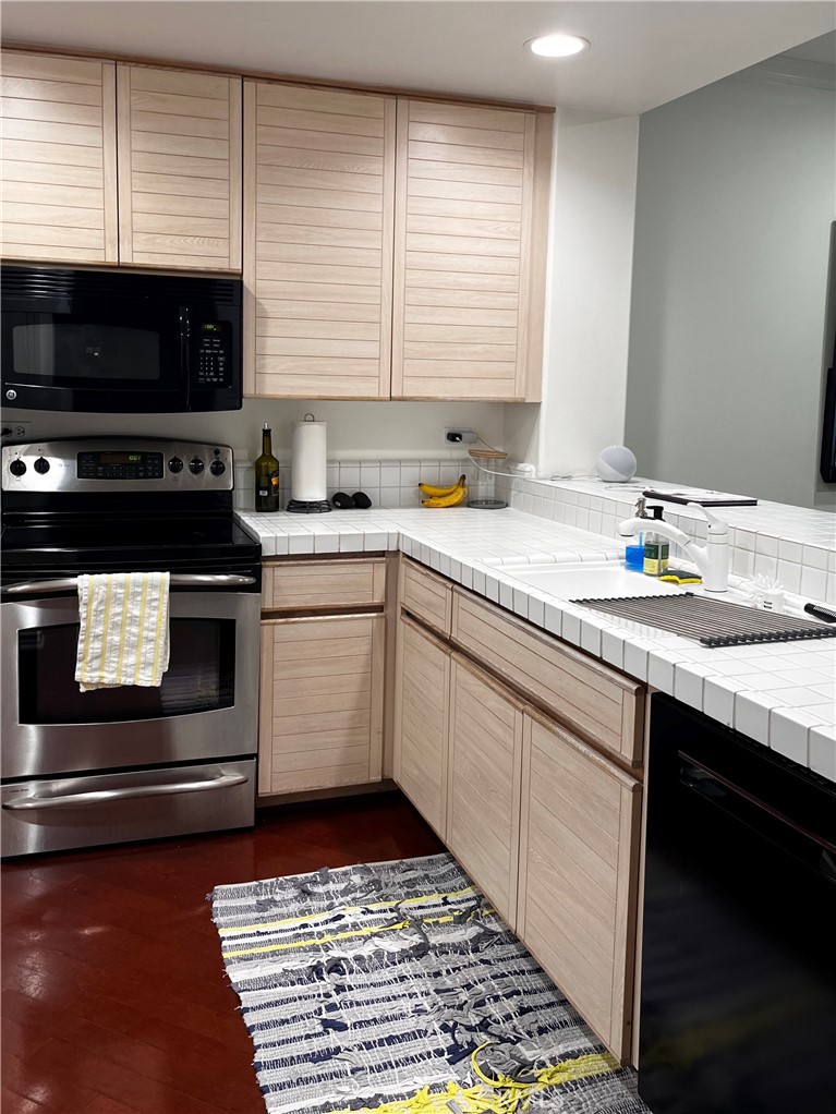 2243 Martin, Unit 409 Irvine, CA 92612 - Photo 5 of 31 a kitchen with a sink stove and microwave