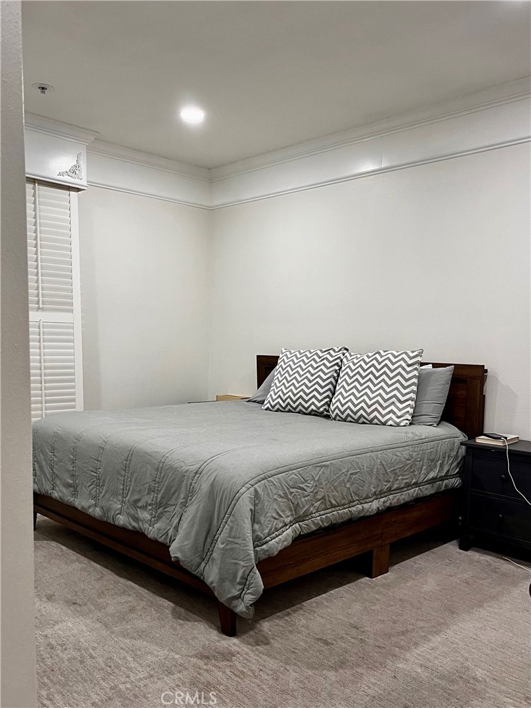 2243 Martin, Unit 409 Irvine, CA 92612 - Photo 9 of 31 a bedroom with a bed and wooden floor
