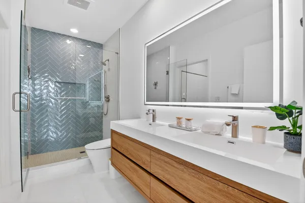 a kitchen with stainless steel appliances granite countertop a sink a microwave a refrigerator and cabinets