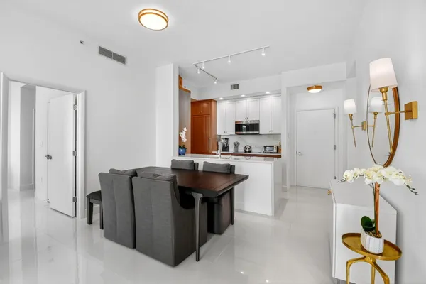 a kitchen with a refrigerator and a sink